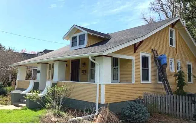 A bungalow painted in a soft dorset yellow